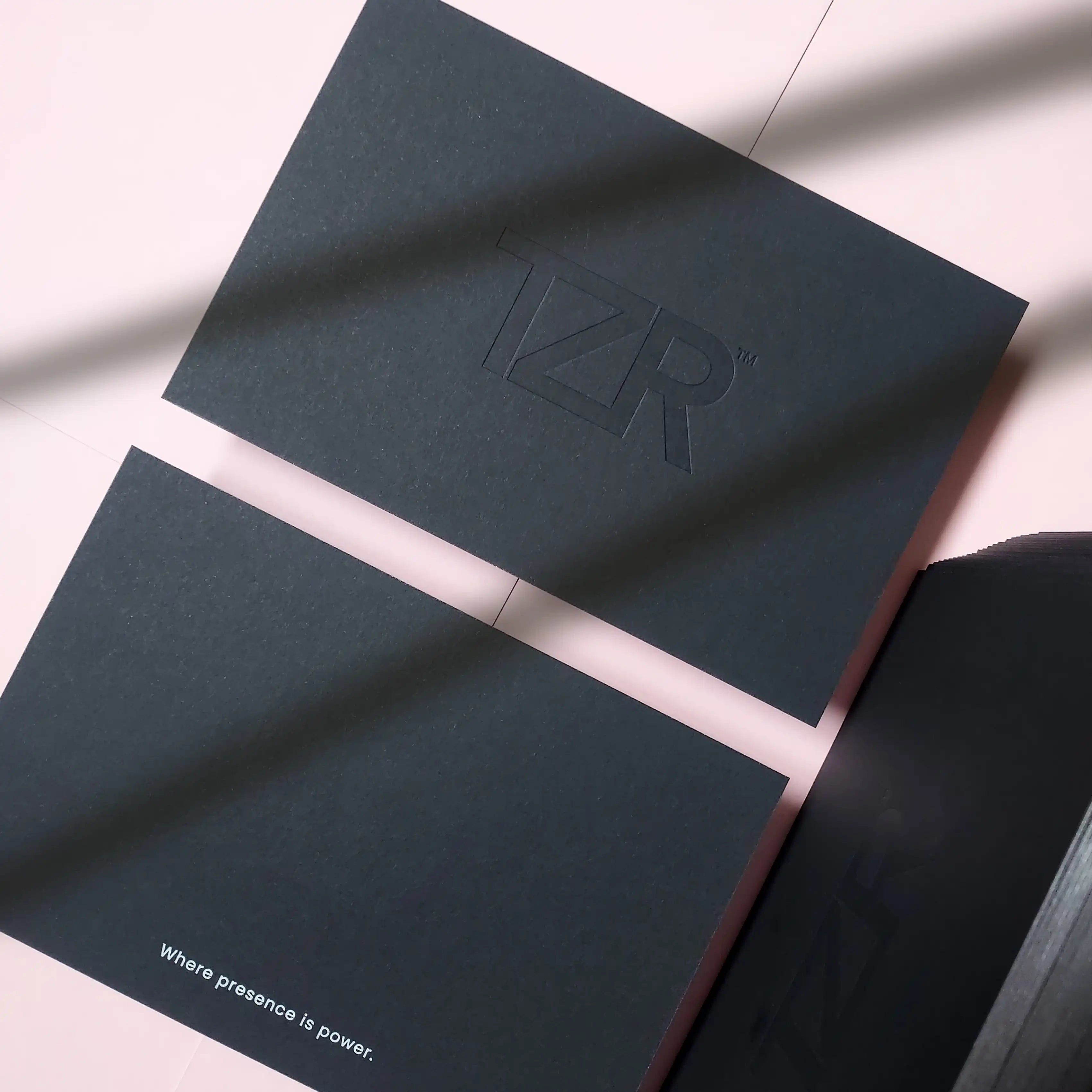 Premium black postcard with debossed logo, white foil headline and silver painted edges - OddPlanPrint