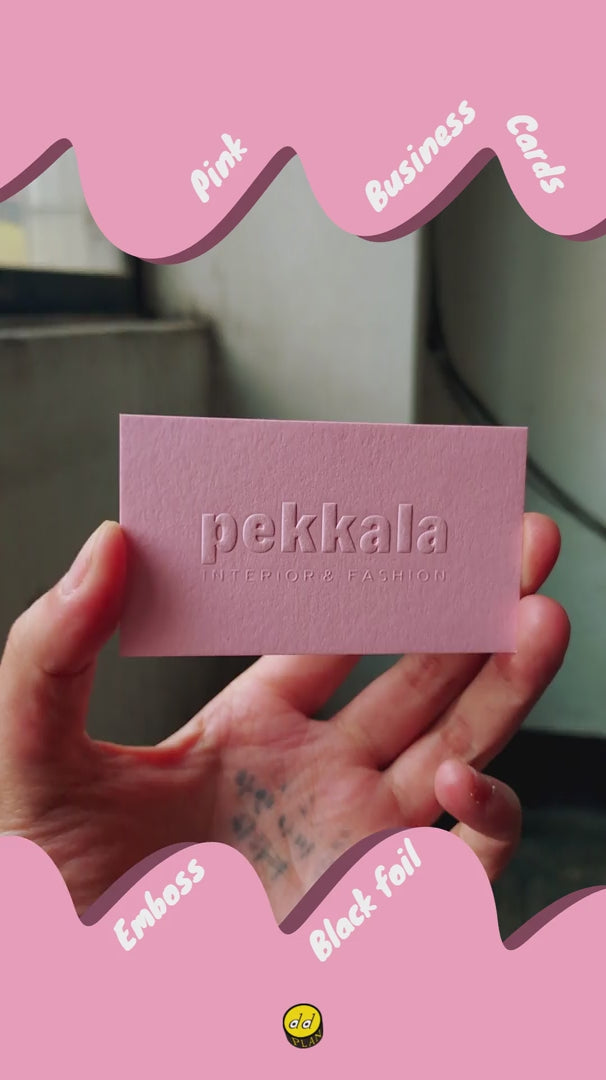 Stack of pink business cards with embossed logo and glossy black foil text - OddPlanPrint